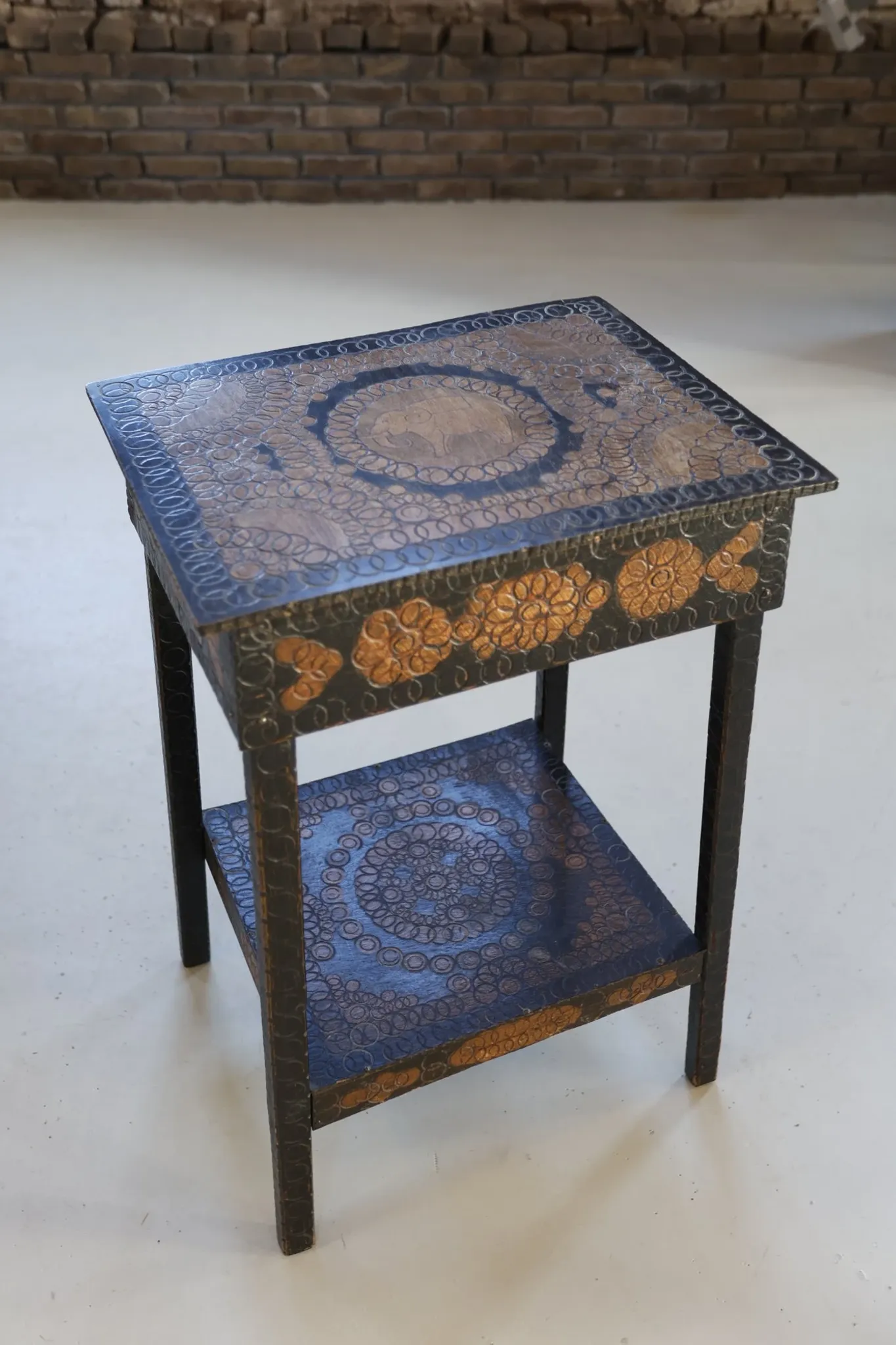Decorated antique side table with elephant