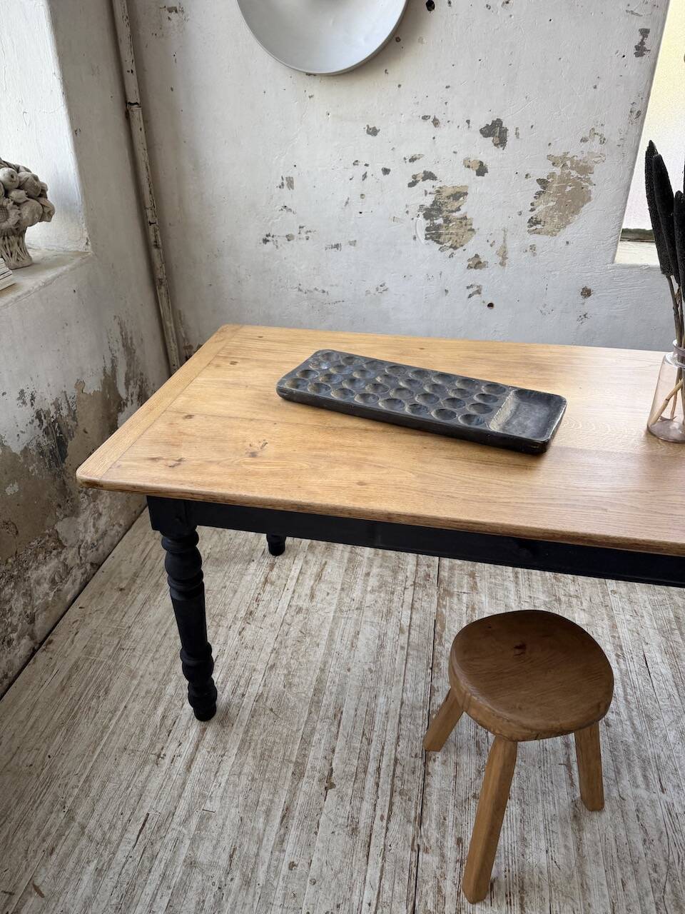 Oak farmhouse table with turned black legs.