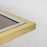 Table basse en laiton doré et verre fumé. Années 1970.