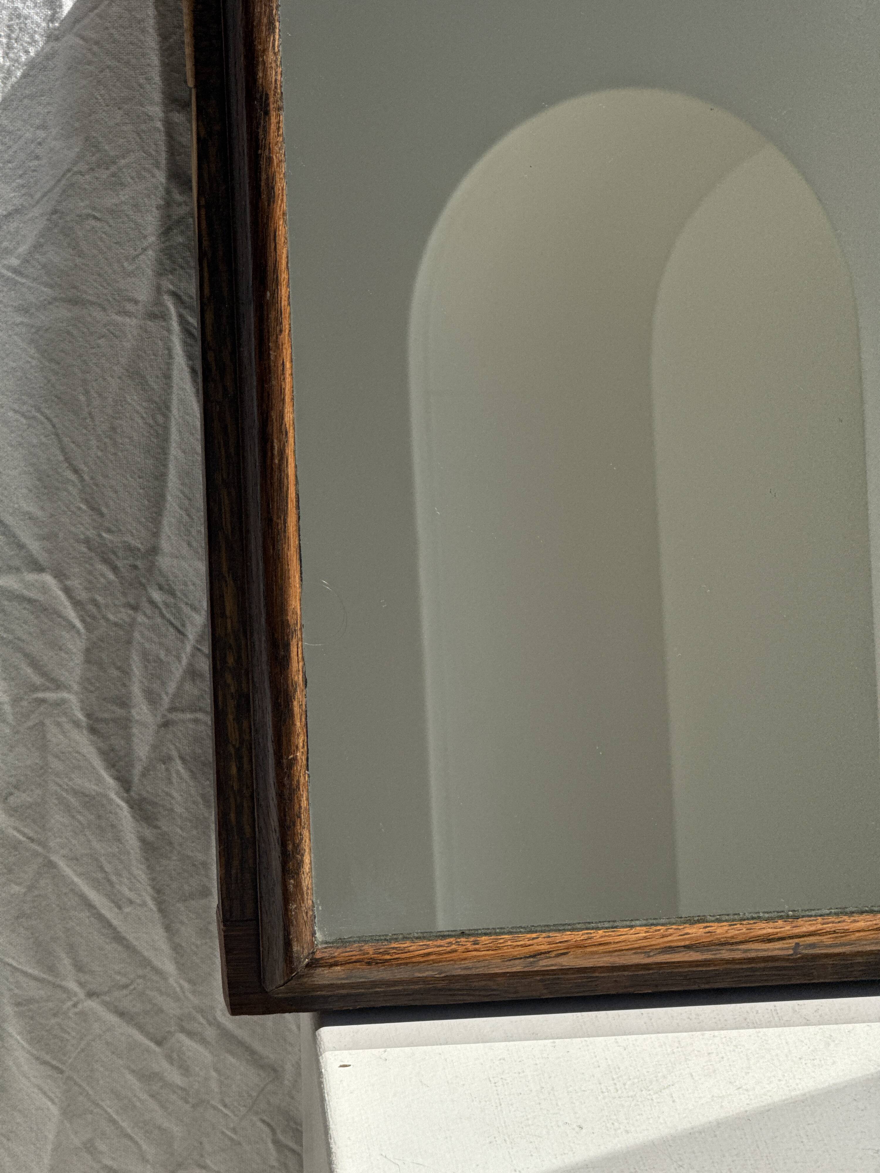 Small antique English rectangular mirror with pediment and oak frame