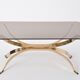 Gold Colored Mid-Century Modern coffee table with smoked Glass top