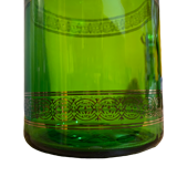 Green apothecary jar with golden patterns