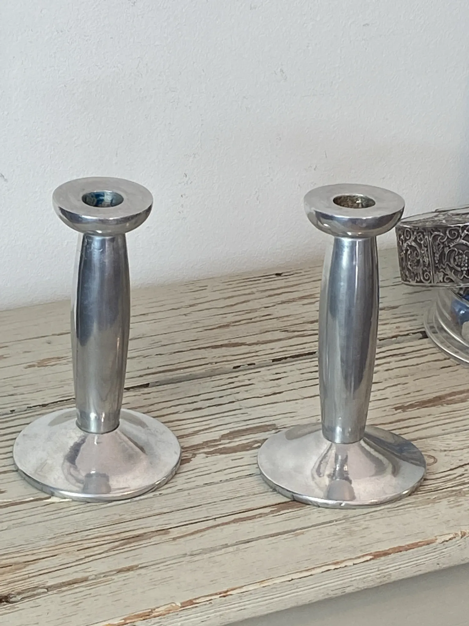 Pair of minimalist polished aluminium candle holders