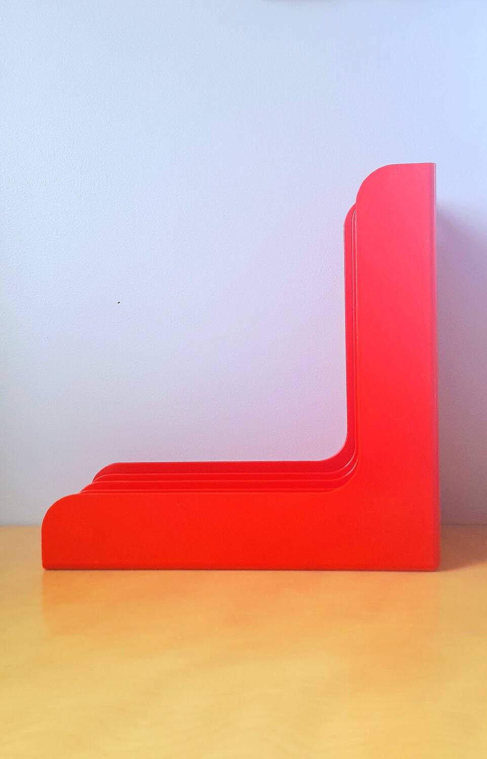 33 rpm vinyl record rack, in orange 70s plastic.