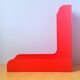 33 rpm vinyl record rack, in orange 70s plastic.