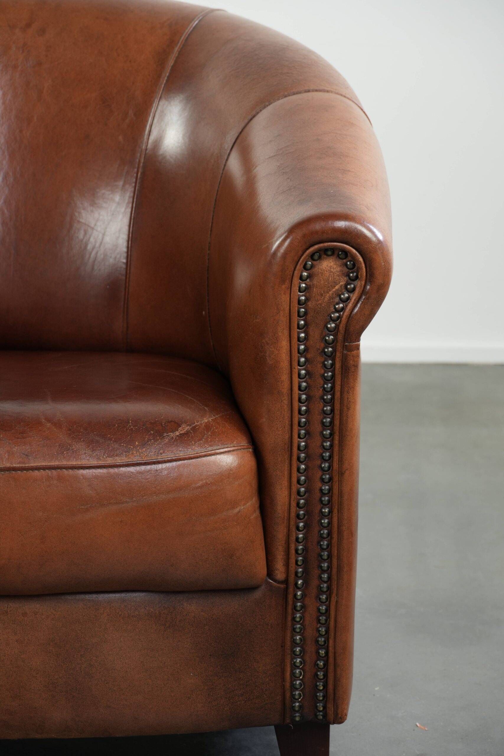 Vintage sheepskin club armchair in English style with deep colours