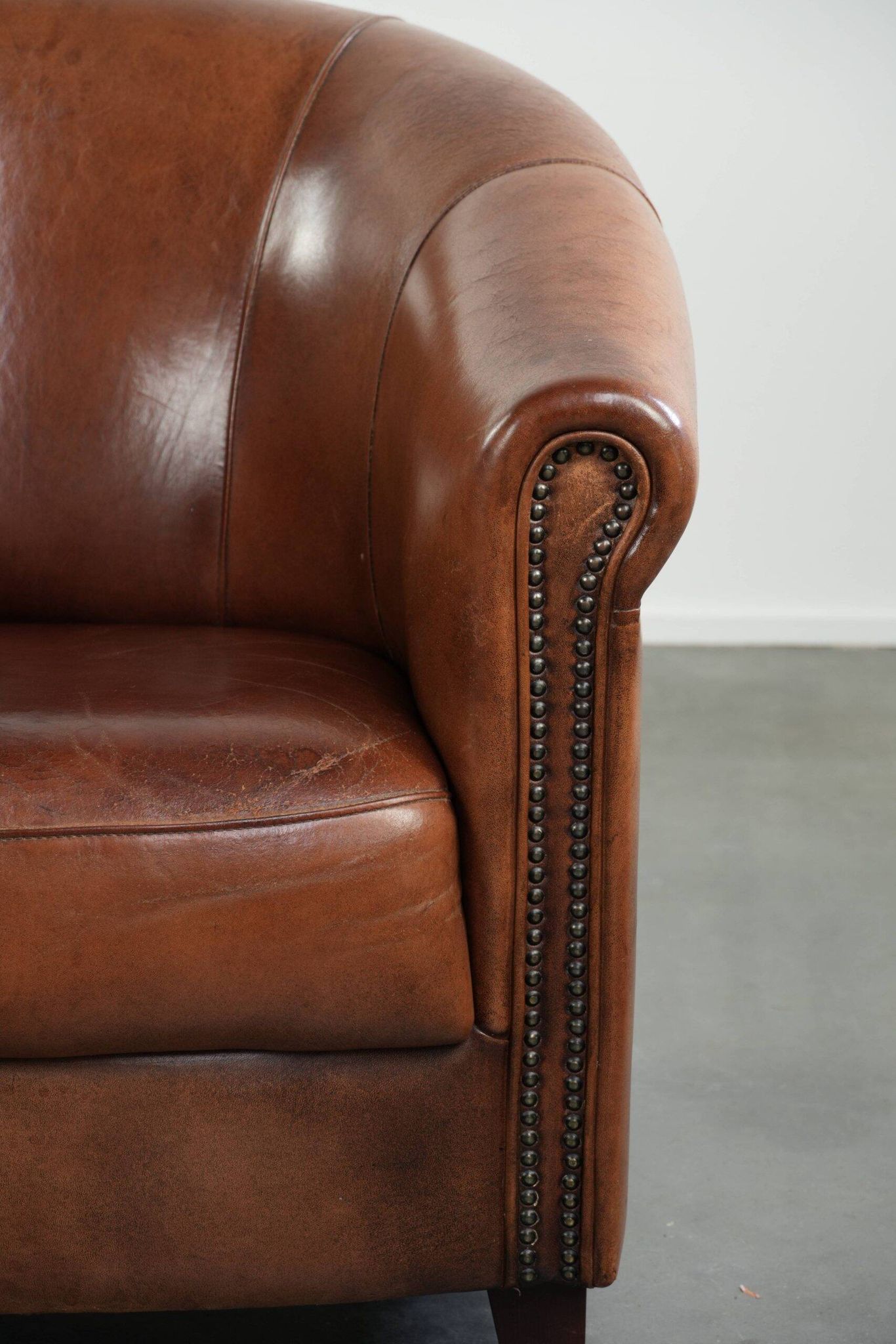 Vintage sheepskin club armchair in English style with deep colours