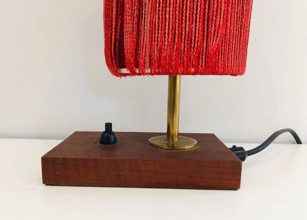 Small lamp made of wood, brass, and wool.