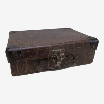 Old cardboard suitcase imitation crocodile brown