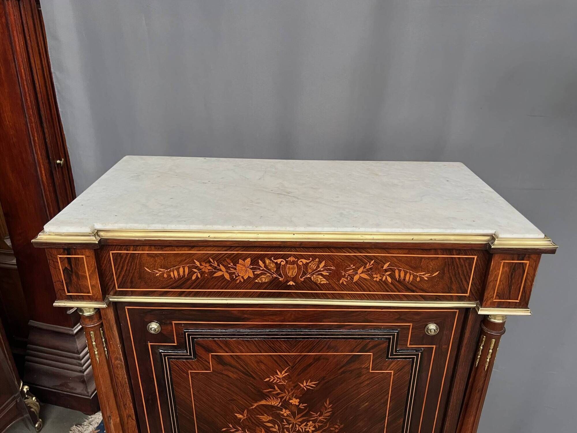Elegant Napoleon III style commode with fine marquetry, gilded bronze mounts, and a marble top.