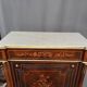 Elegant Napoleon III style commode with fine marquetry, gilded bronze mounts, and a marble top.