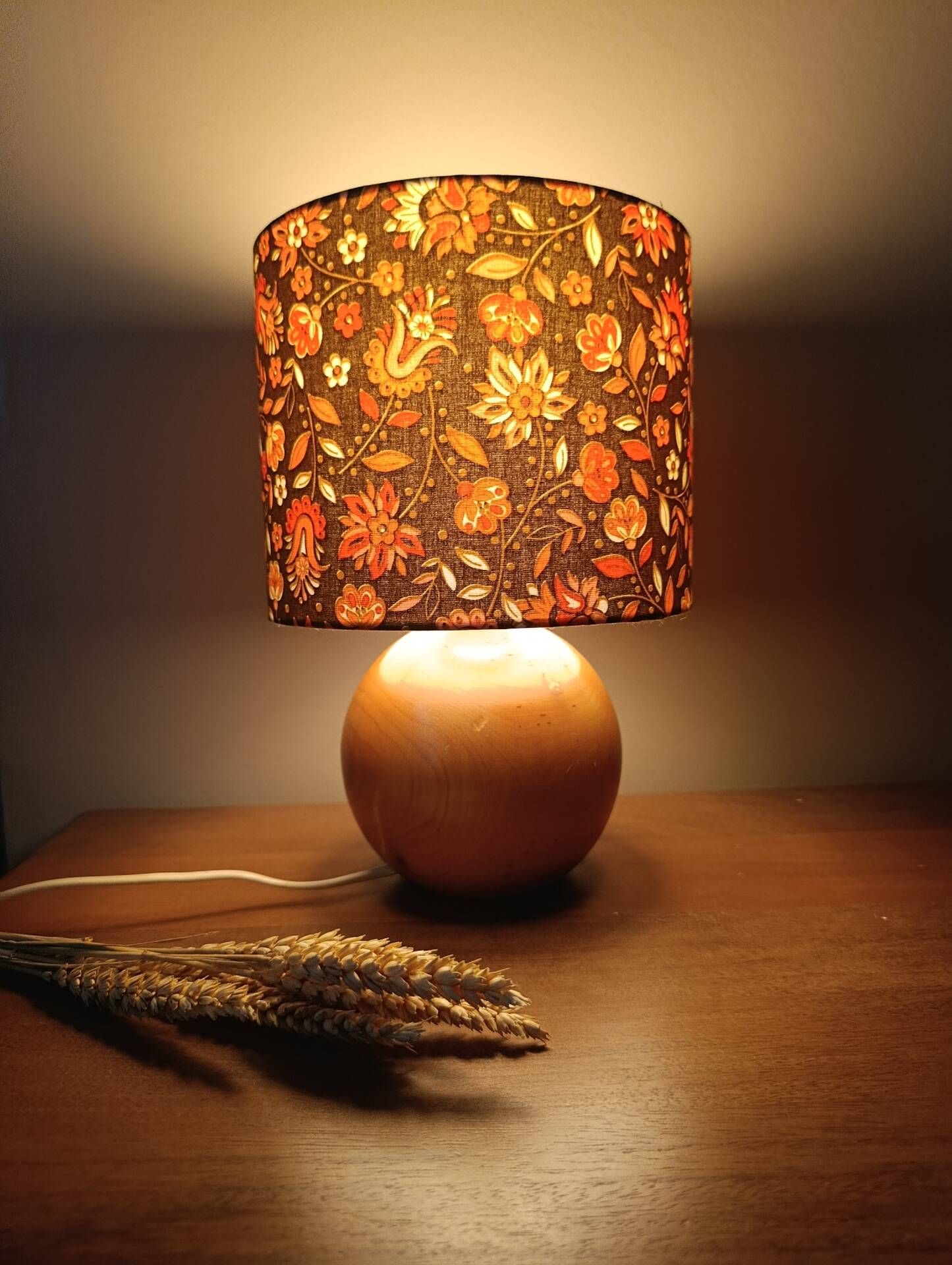 Table lamp with a wooden ball base, floral print in bohemian style.
