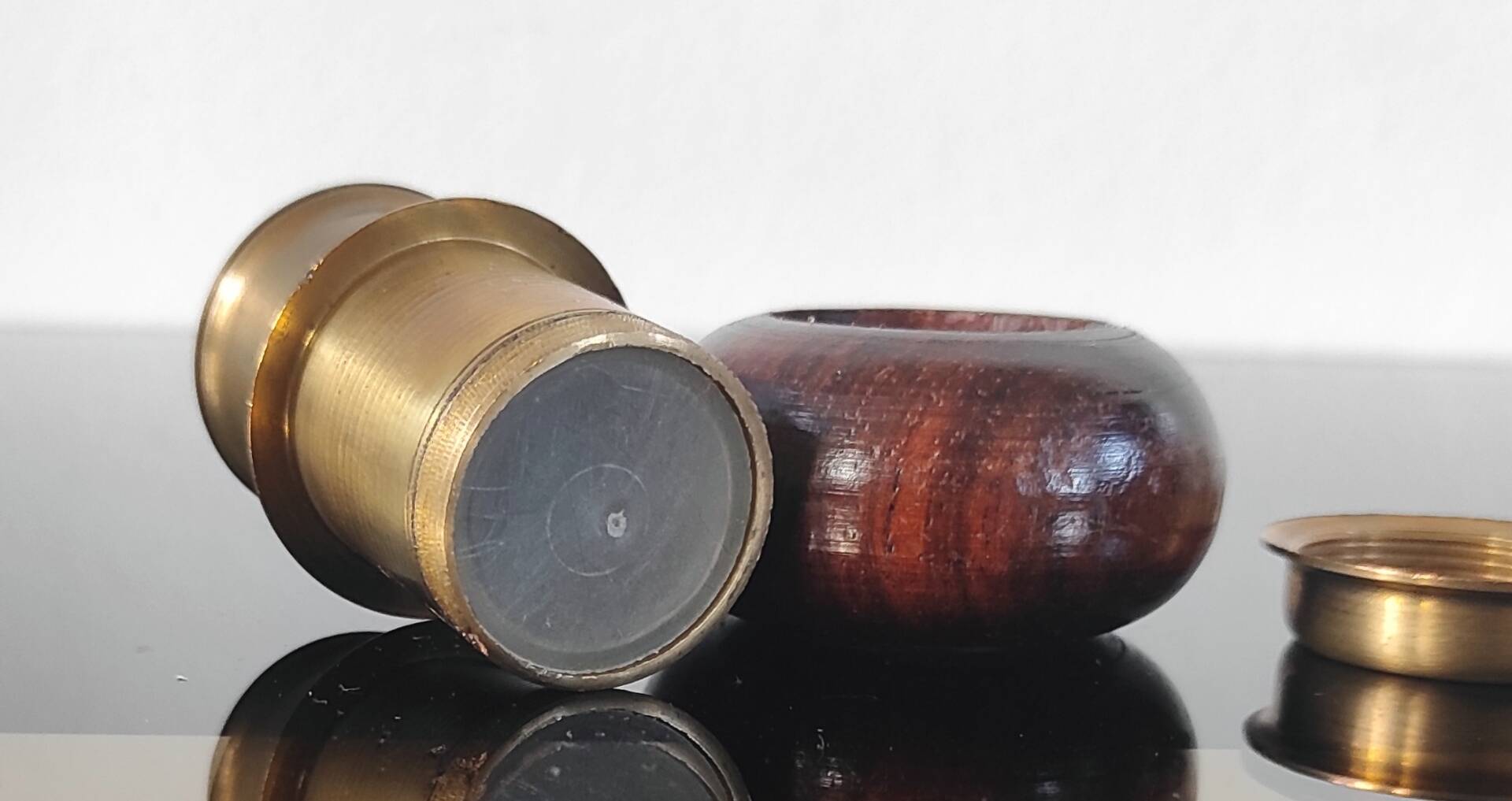 Vintage salt and pepper shaker duo in brass and turned wood.