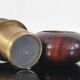 Vintage salt and pepper shaker duo in brass and turned wood.
