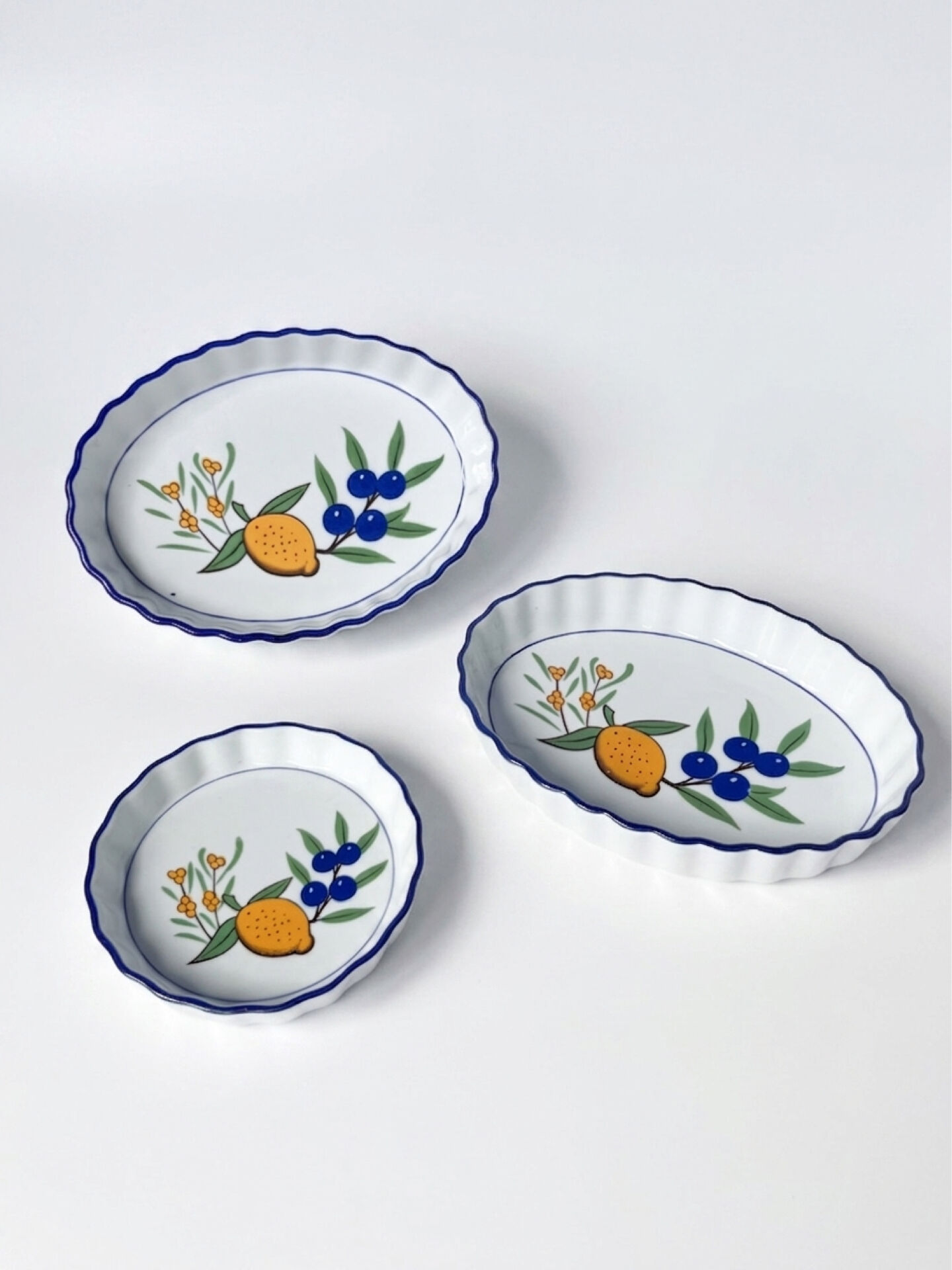 Set of 3 vintage ceramic dishes with wicker baskets.