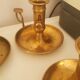 Many candlesticks and a small oil lamp.