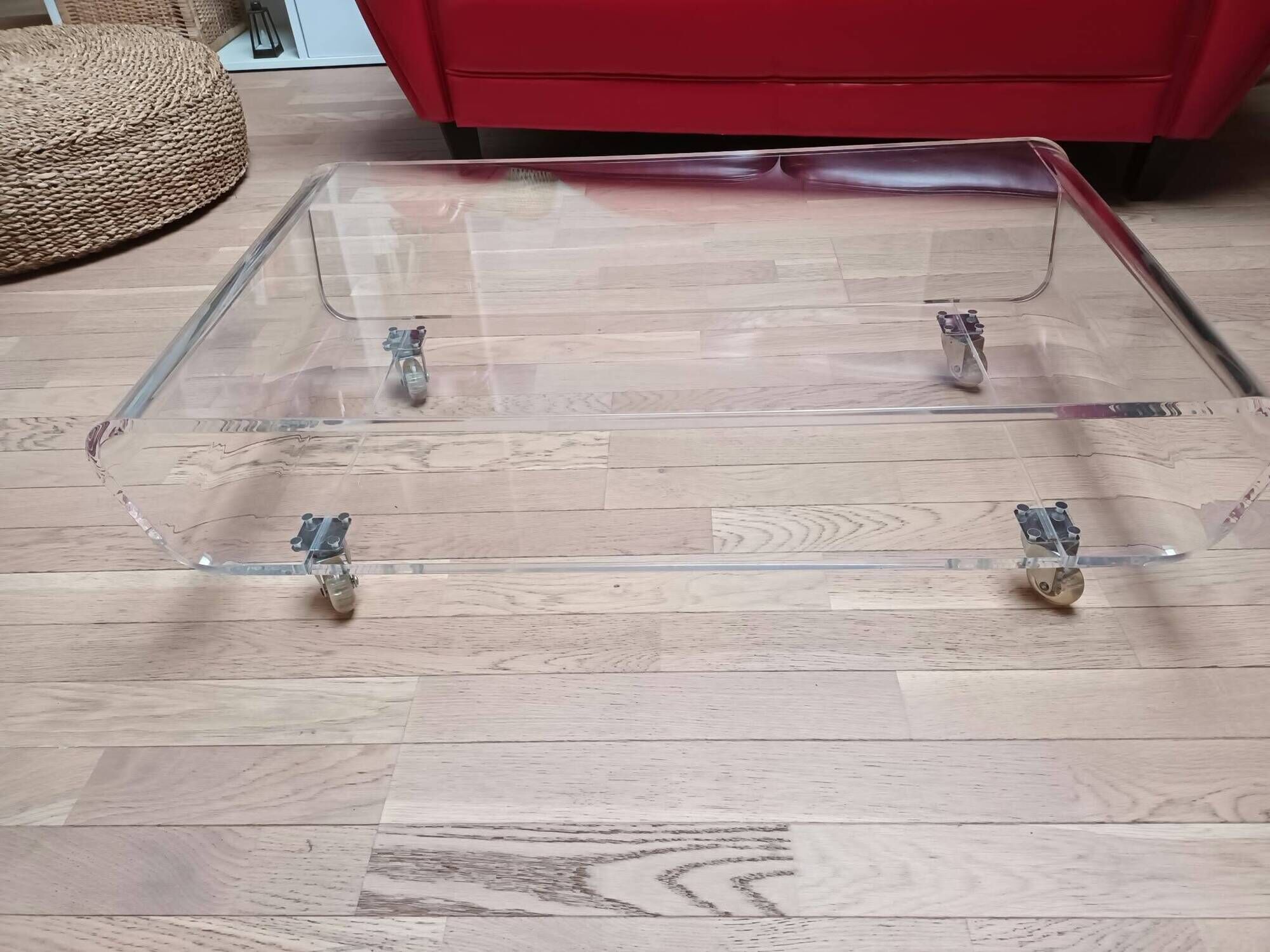 Design coffee table from Habitat in transparent plexiglass, mounted on wheels.