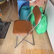 Brown folding chair in vinyl and steel