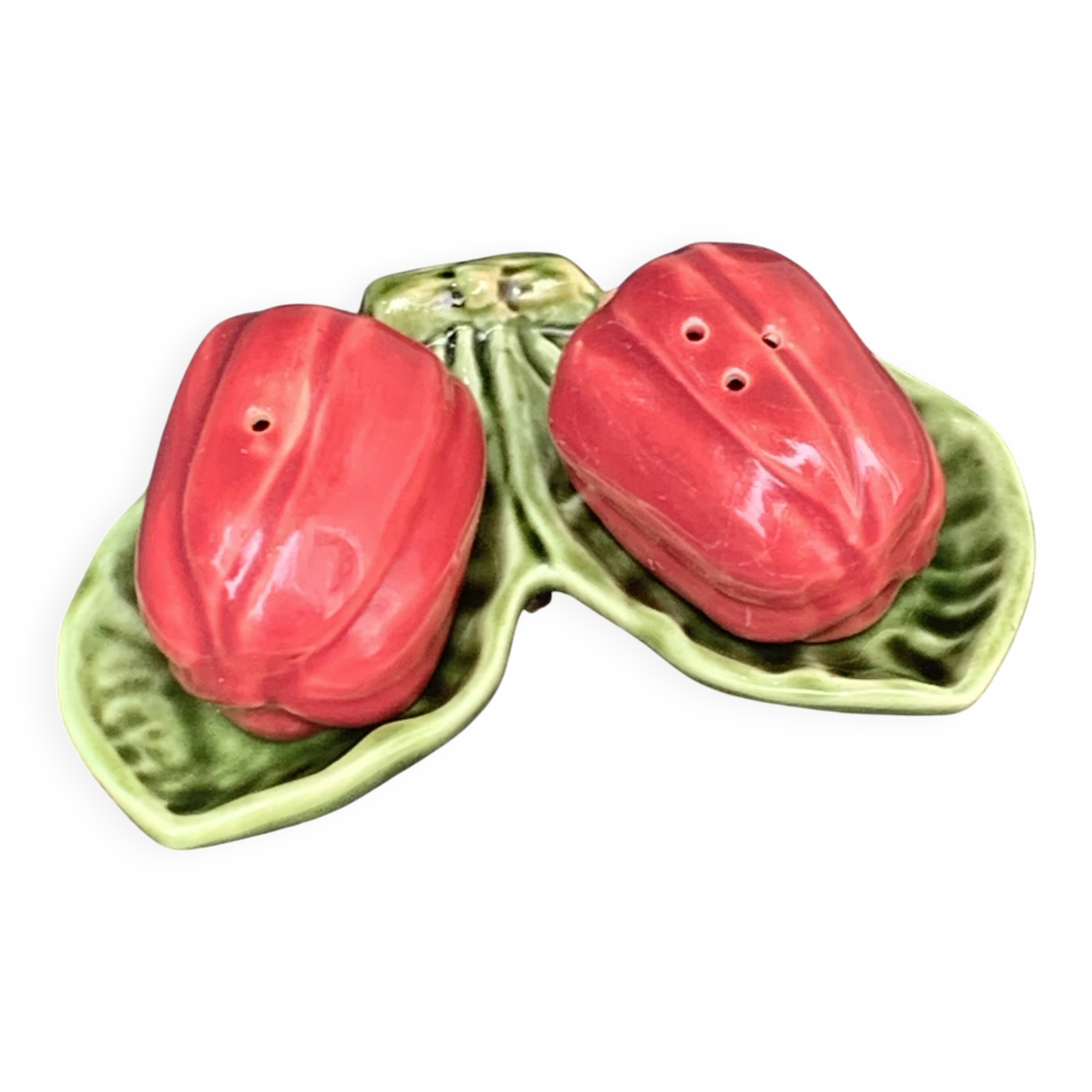 Ceramic salt shakers, slip in the shape of peppers.