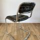 Set consisting of a table in chrome and smoked glass and its 4 tubular chairs in chrome and skaï a