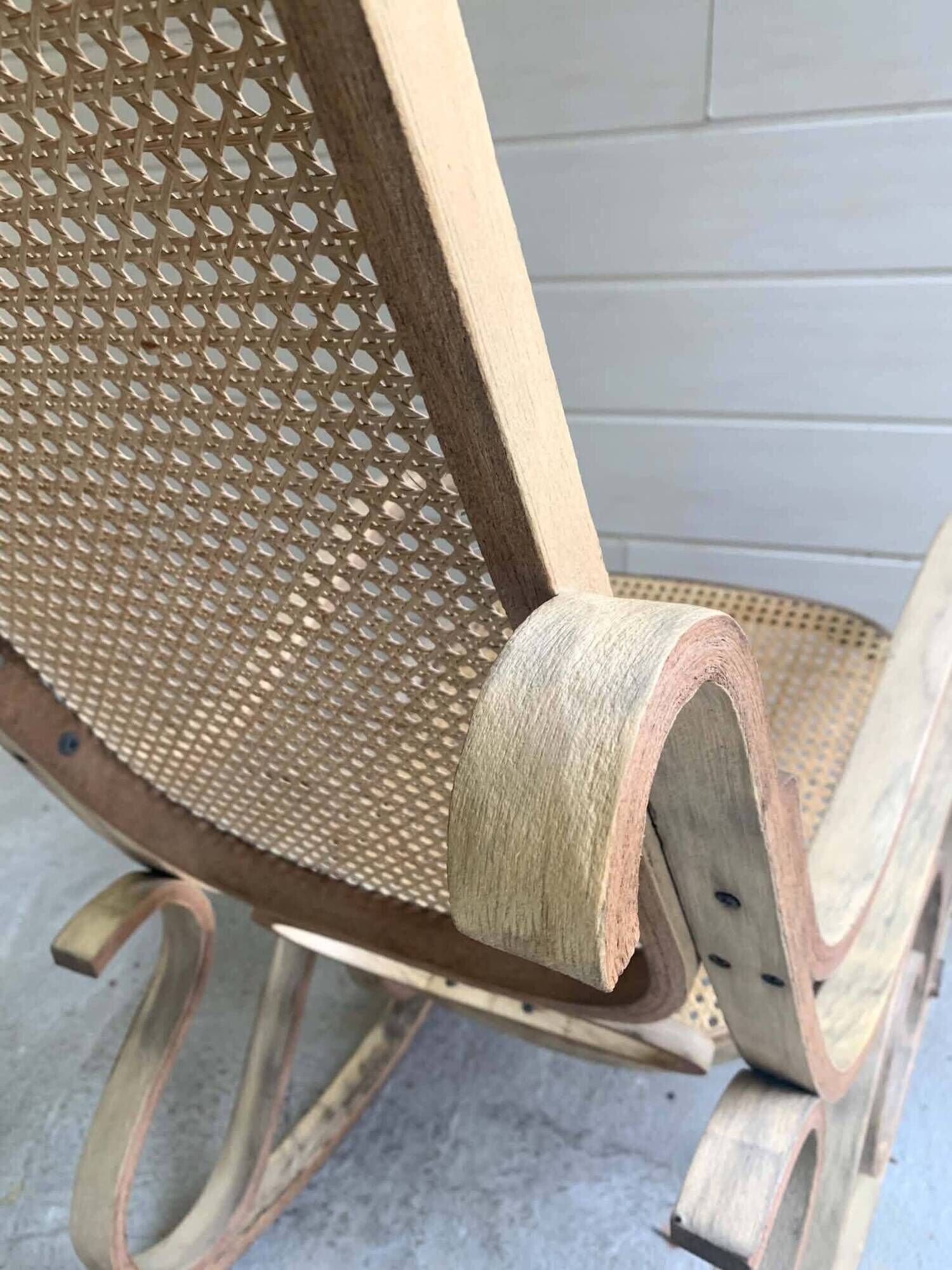 Rocking chair with a cane seat and backrest.