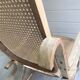 Rocking chair with a cane seat and backrest.