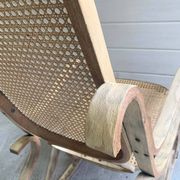 Rocking chair with a cane seat and backrest.
