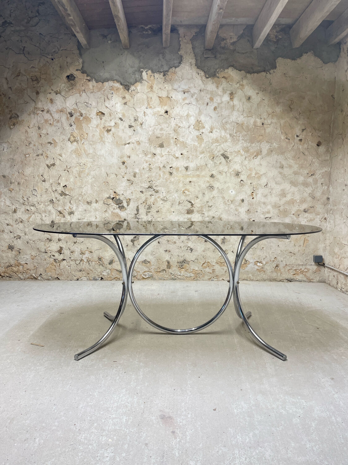 Smoked glass oval table from the 1970s.