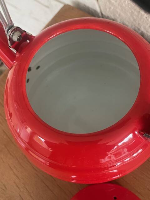 Old red enameled kettle