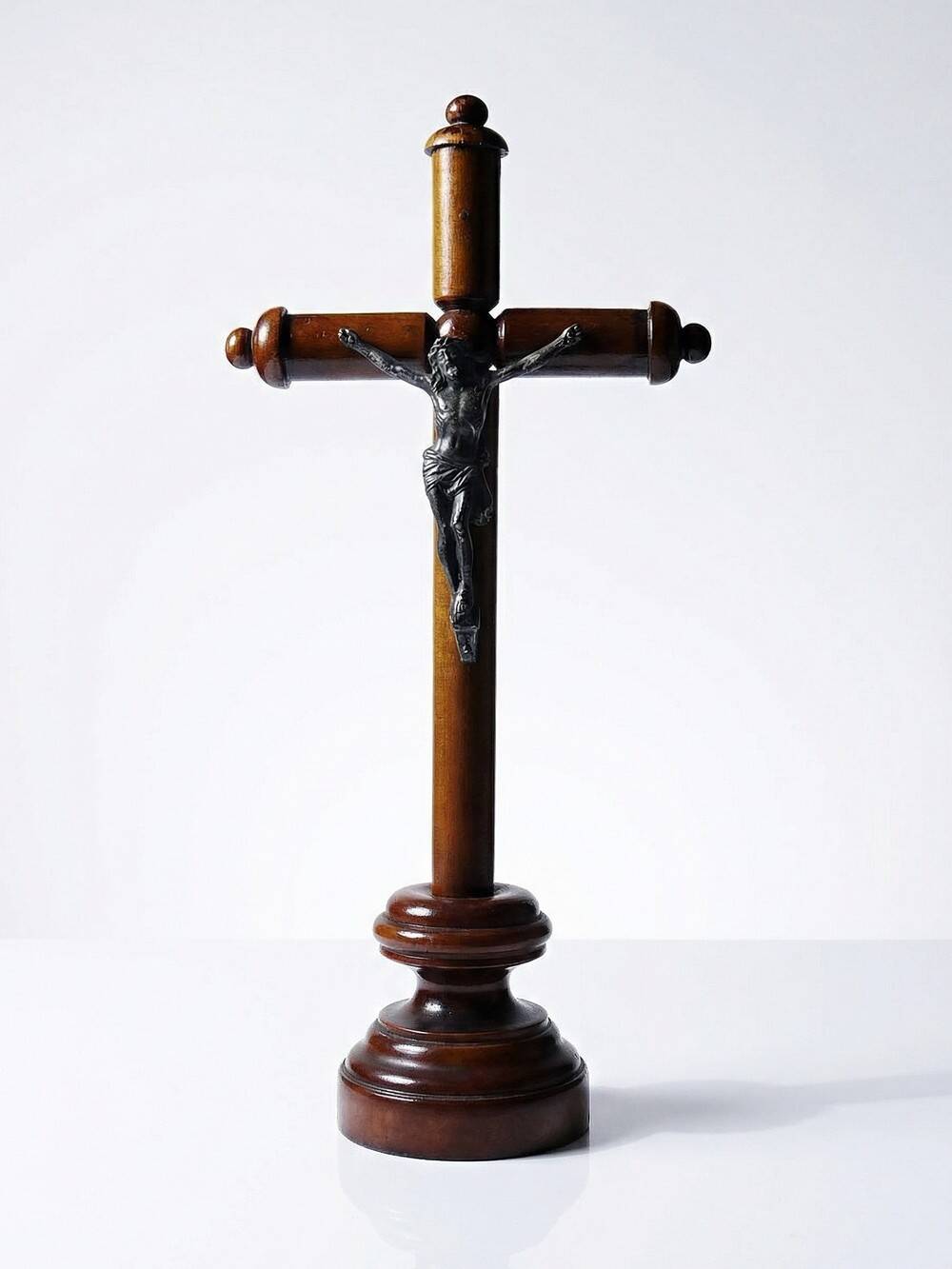 Antique wooden altar crucifix with a turned design and silver-plated Christ.