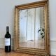 Antique French giltwood wall mirror in gold