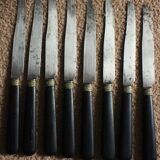 A set of 8 small knives with black wooden ferrules