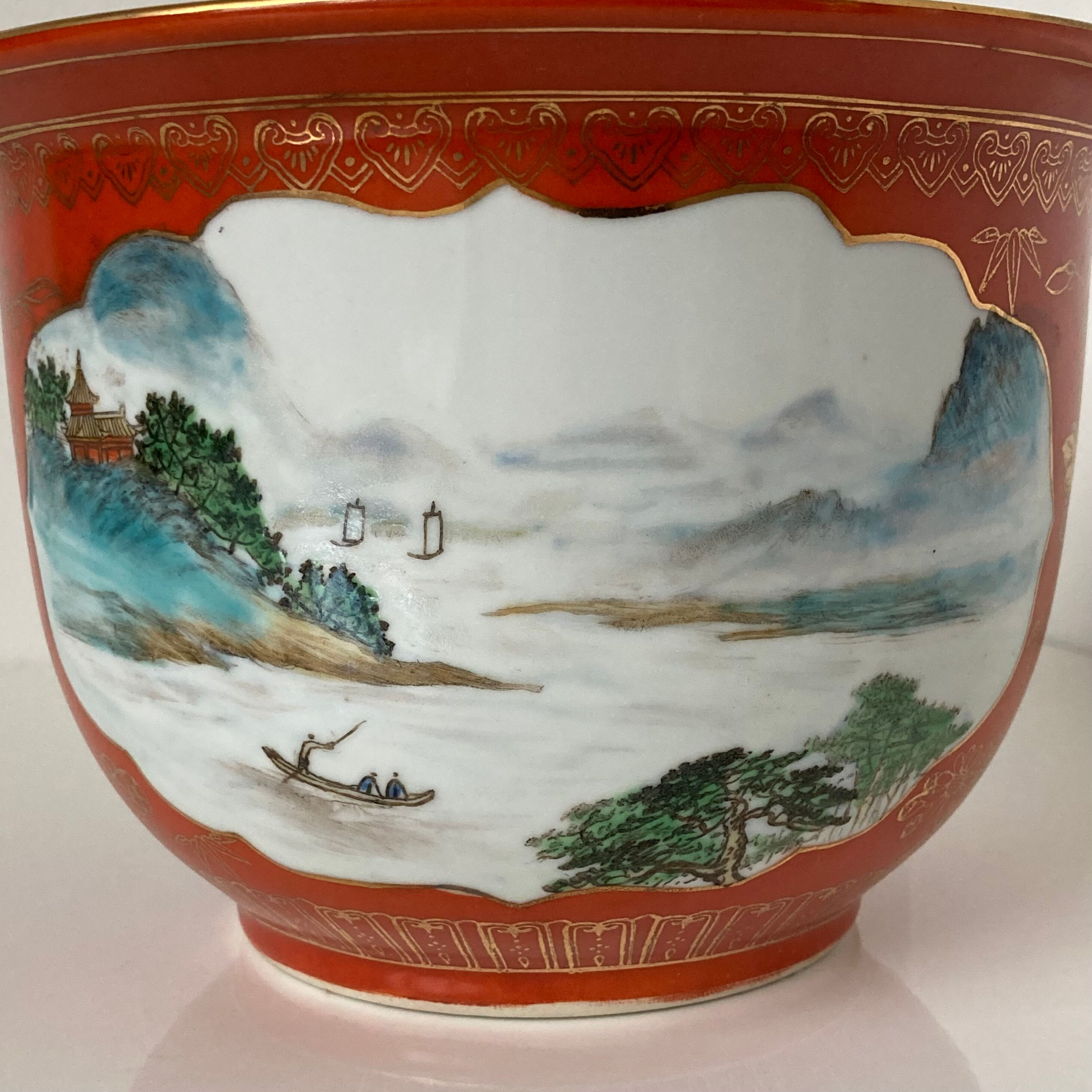 Chinese planter or Chinese porcelain pot cover decorated with landscapes on a coral and golden background