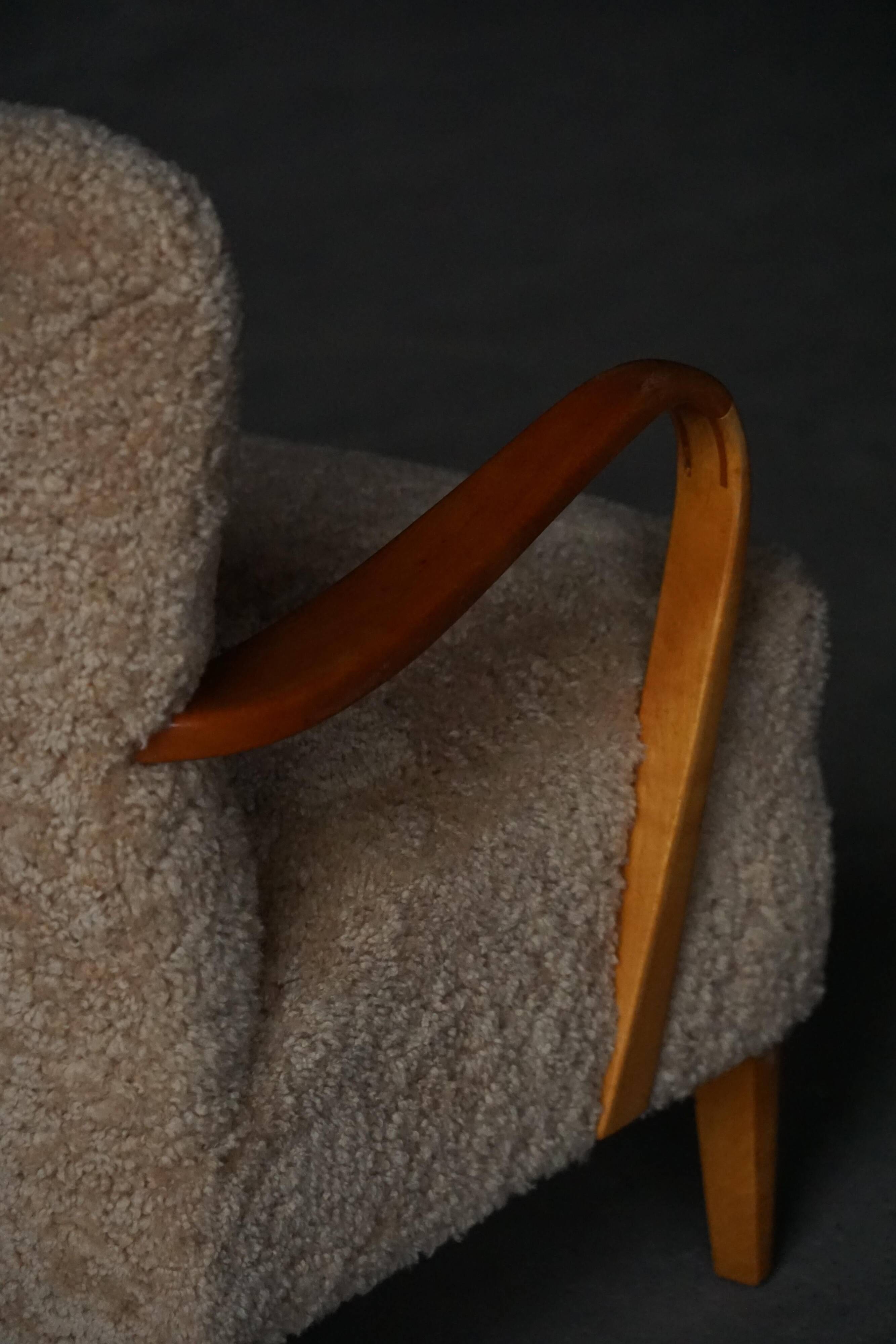 Pair of Mid Century Modern Swedish lounge chairs in birch and lamb's wool, 1960s.