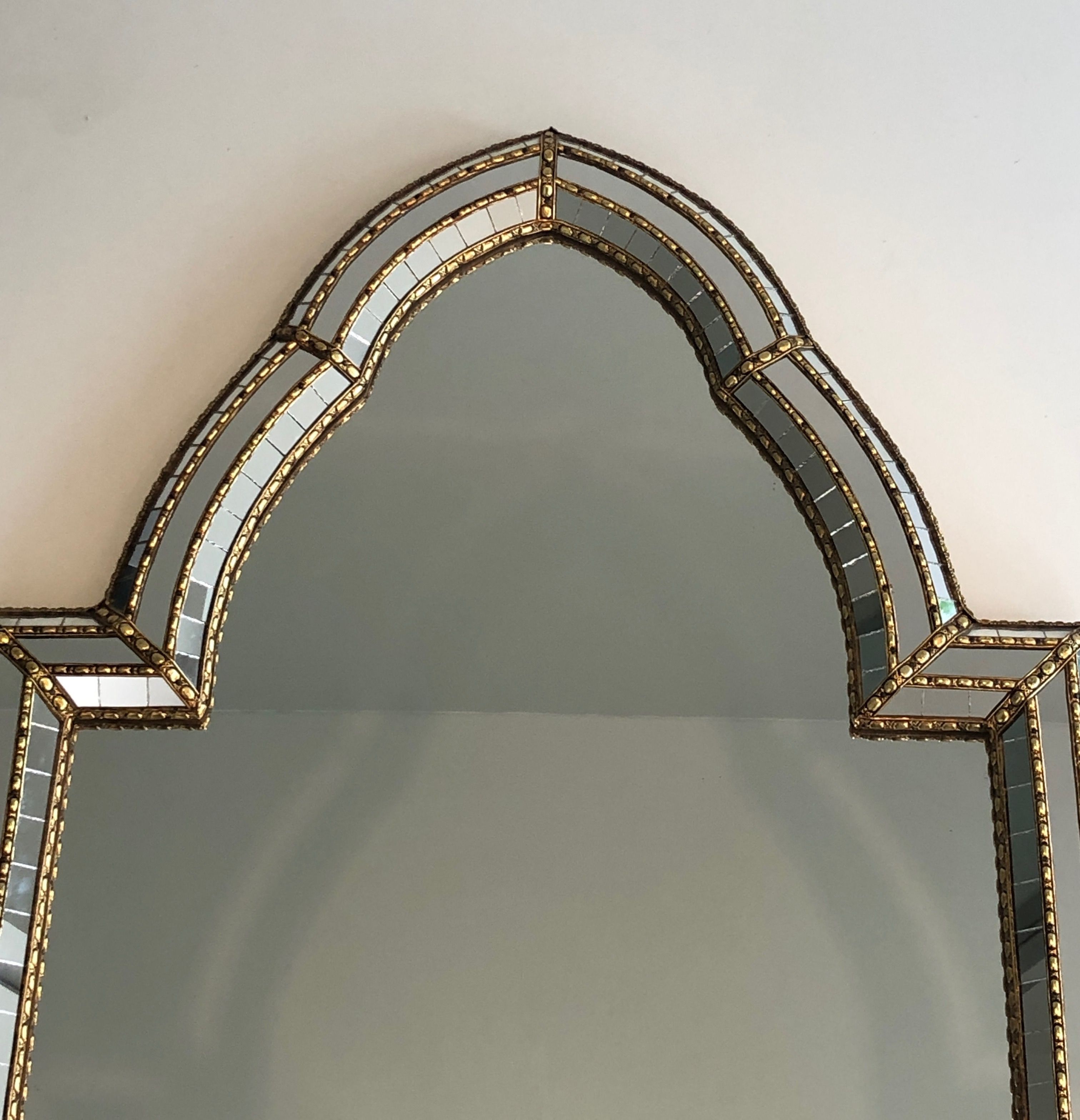 Multi-faceted mirror and brass garlands