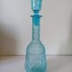 Old turquoise blue molded glass liqueur bottle and its cap