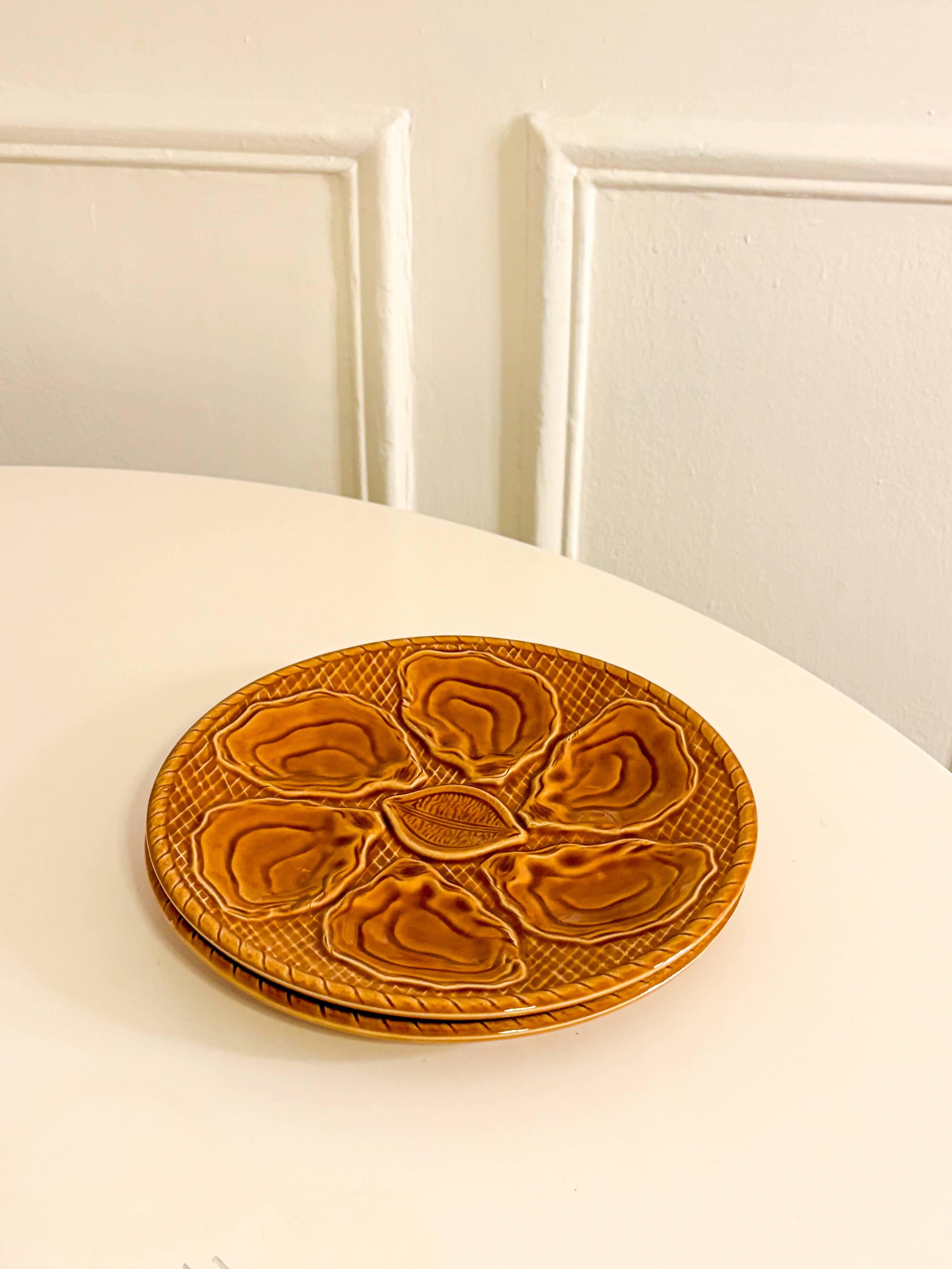 Pair of slip oyster plates, Brown, 1960