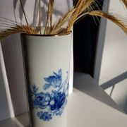 White porcelain vase from Limoges with blue decoration and gold rim.