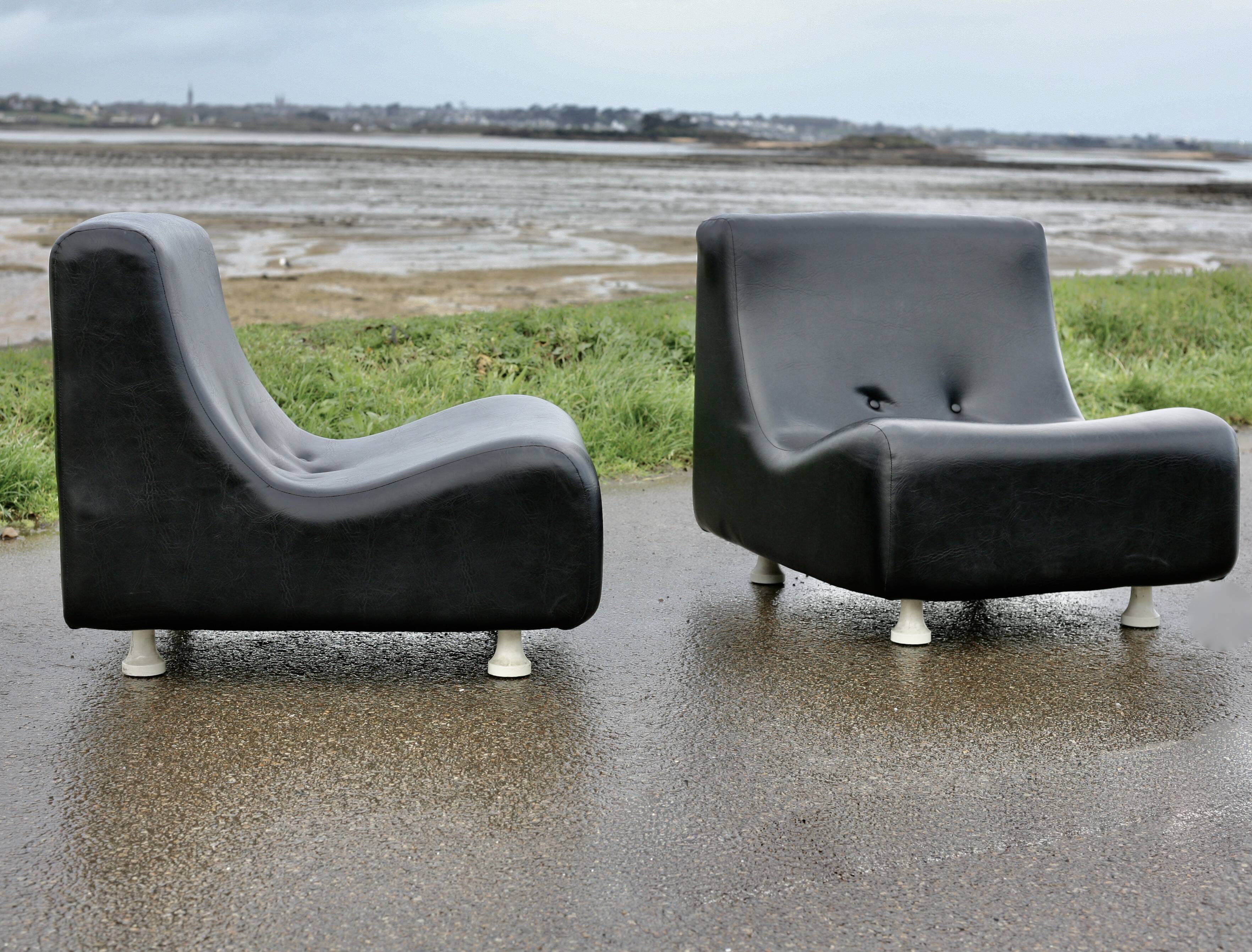 Pair of “space age” low chairs. Black faux leather. Circa 1970