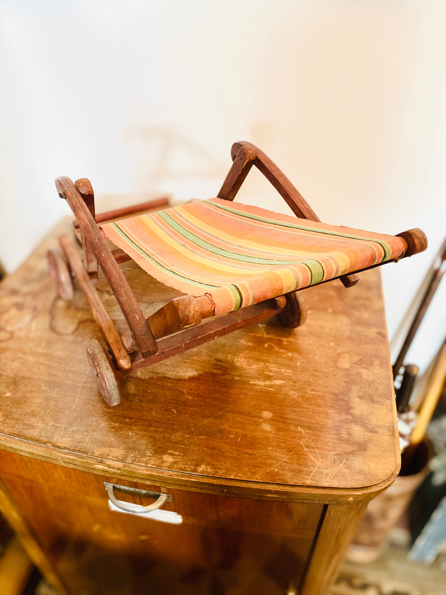 Vintage wooden folding doll's deckchair on wheels