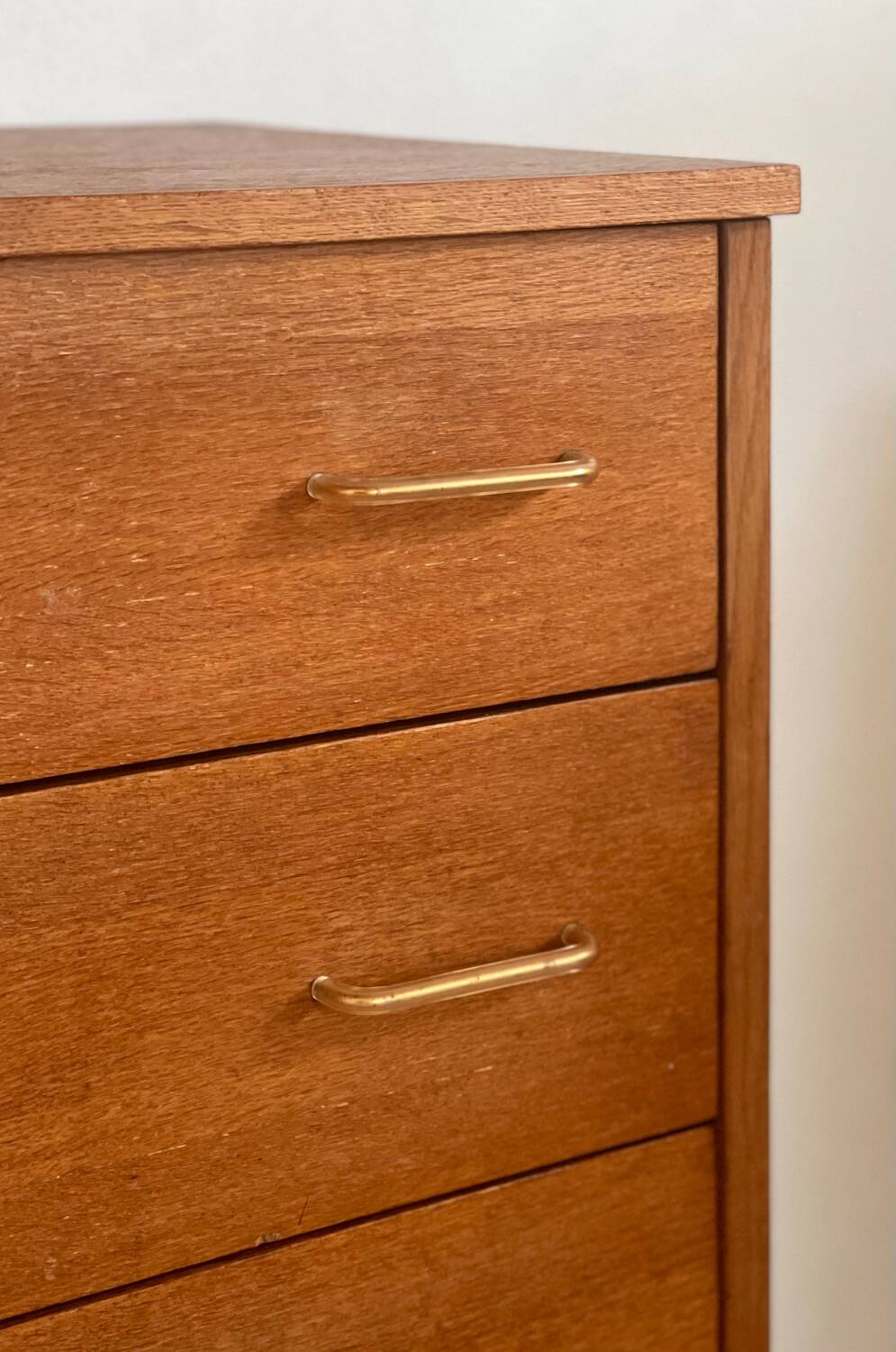 Vintage 1960s chest of drawers with covered handles.