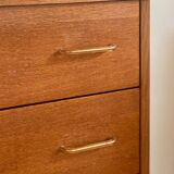 Vintage 1960s chest of drawers with covered handles.