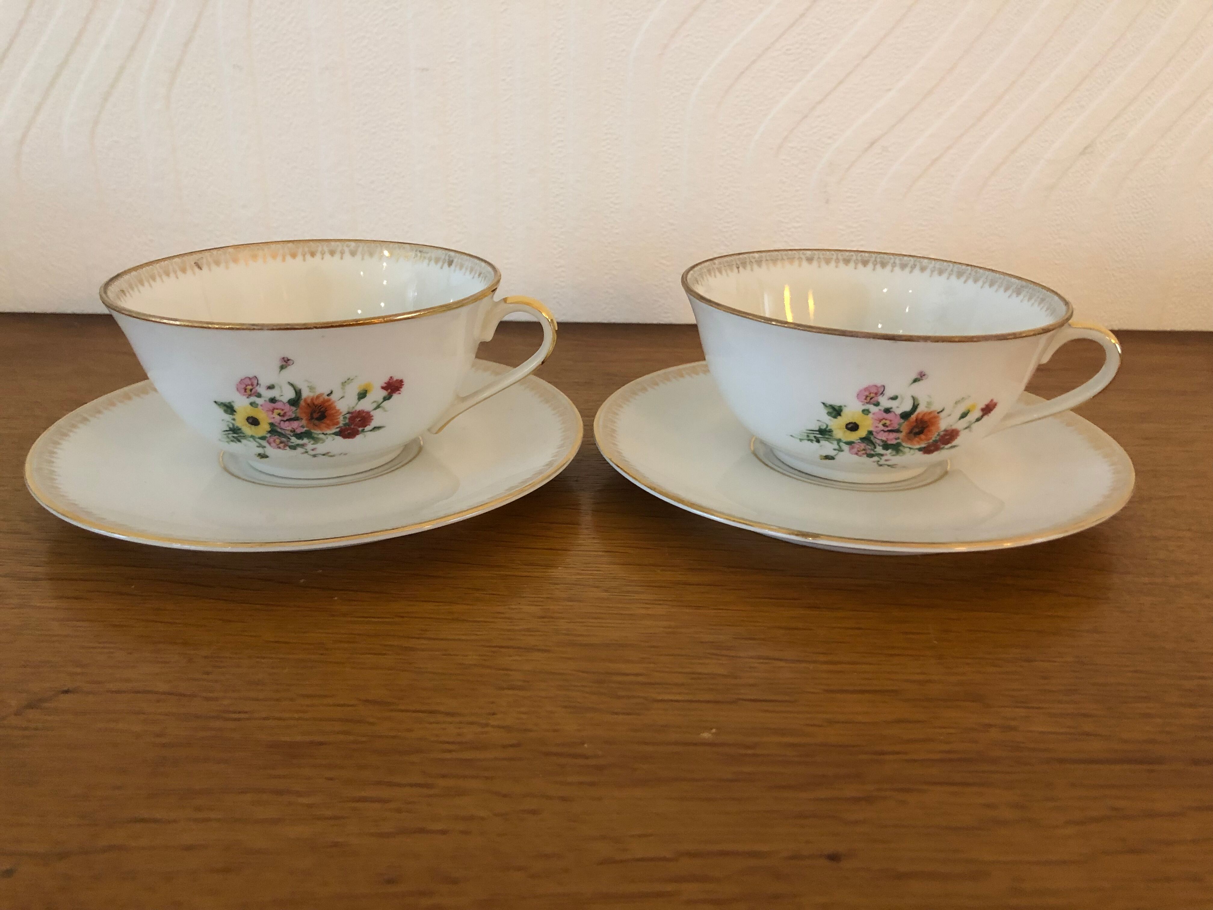 2 porcelain teacups and under teacups floral motifs