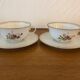 2 porcelain teacups and under teacups floral motifs