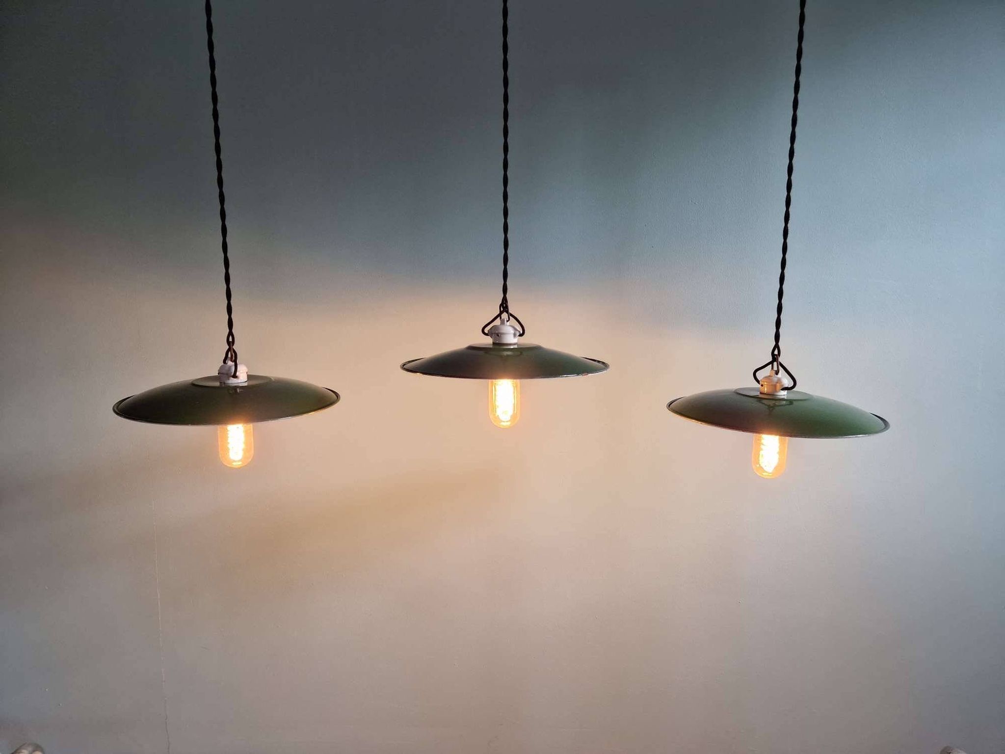 Trio of large industrial suspensions in green enamelled sheet metal.