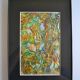 Framed abstract painting under glass
