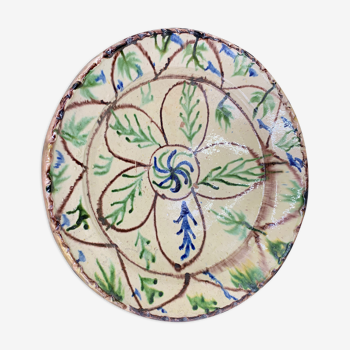 Ancient terracotta dish glazed with brown and green floral decoration on yellow engobe, pakistan multan