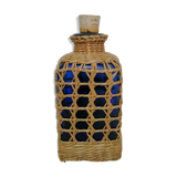 Blue bottle covered with wicker