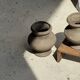 Small brutalist handcrafted terracotta vase with a pedestal, Indonesian, H19 D17.
