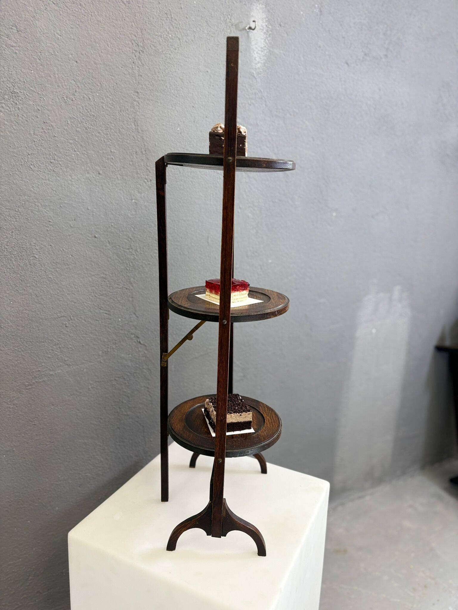 Vintage 3-tier cake stand in dark wood, 1920s serving display.